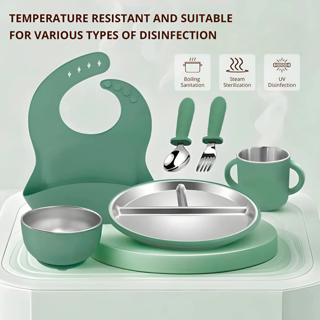 Children's dining set with green tray, bowl, plate, and cup on a light gray background.